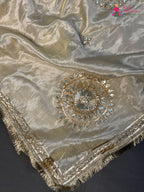 close up detailing of beige pure tissue silk gota patti saree