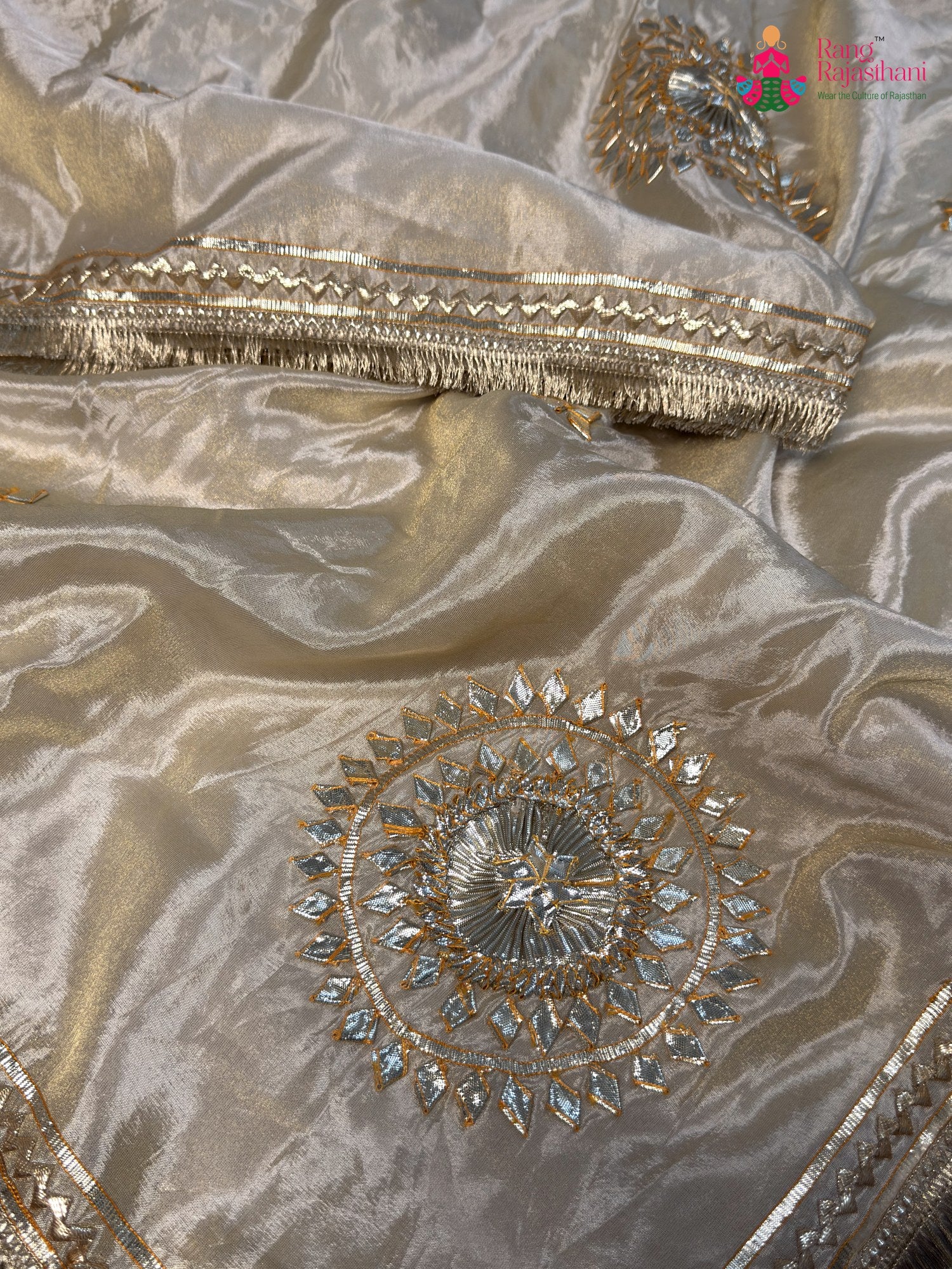 fabric texture of beige pure tissue silk gota patti saree