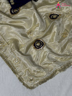 close up detailing of beige pure tissue silk gota patti saree
