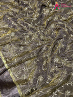 border detail of beige pure tissue silk zari embroidery saree