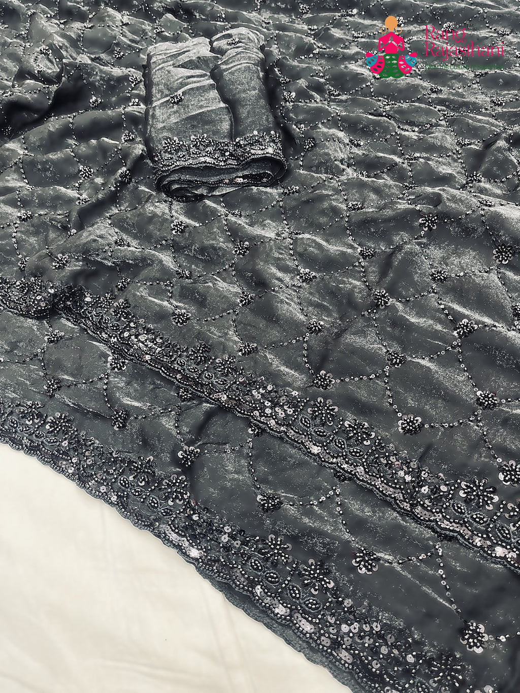 close up detailing of black art silk sequin saree 