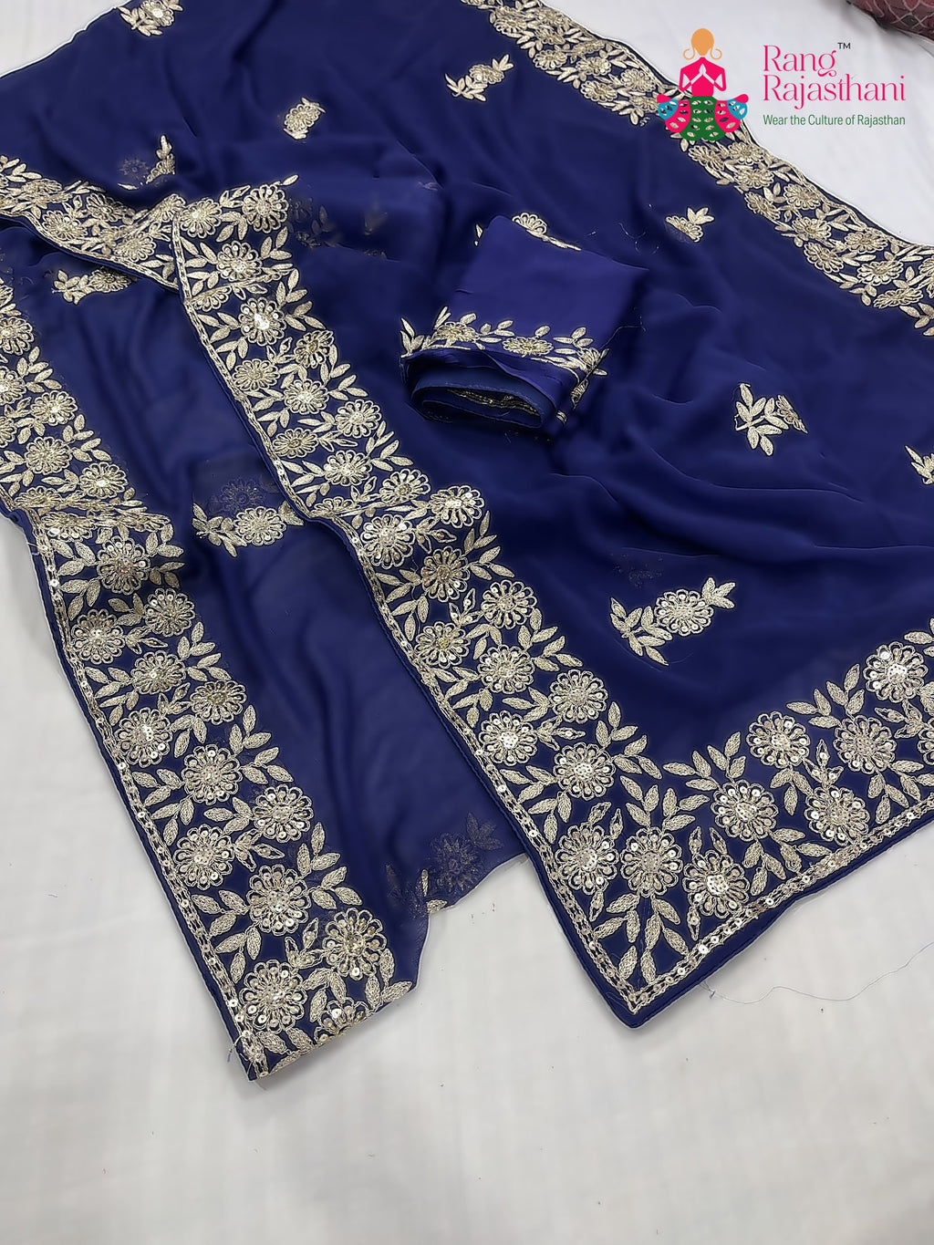 close up detailing of blue chiffon zari embroidery saree