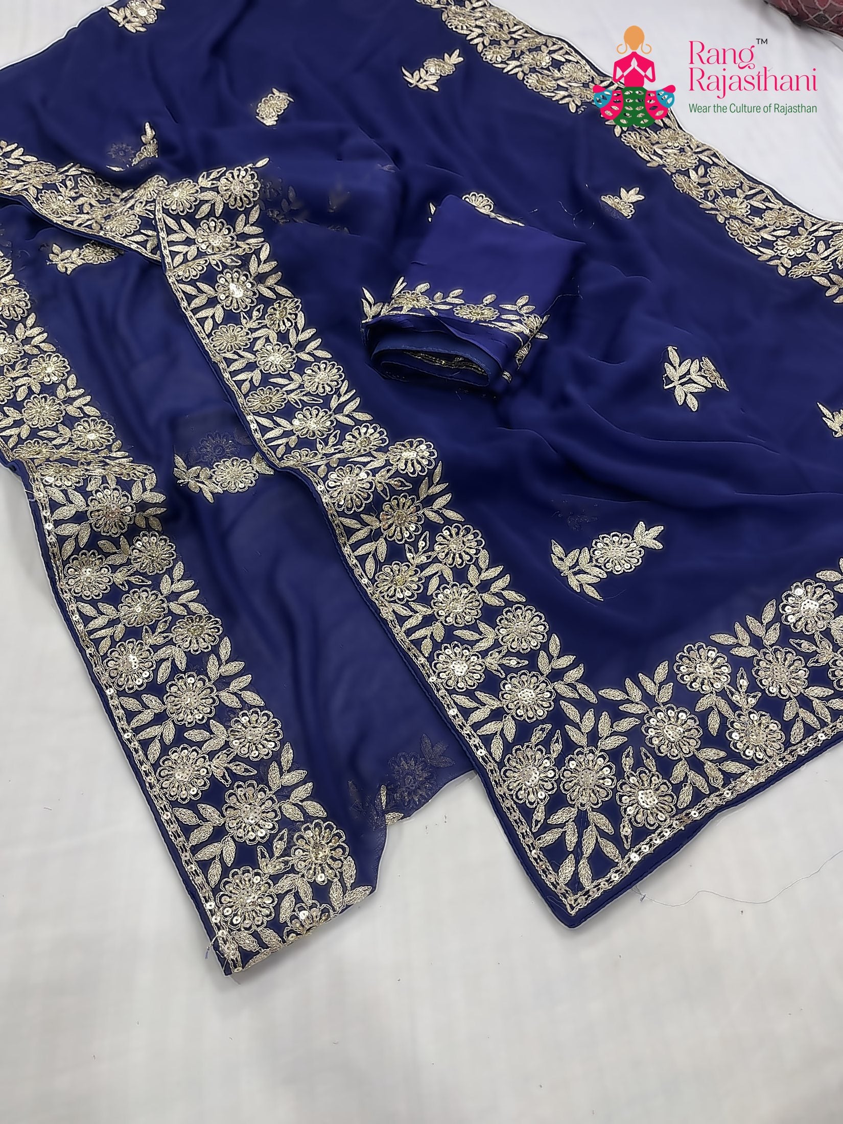 close up detailing of blue chiffon zari embroidery saree