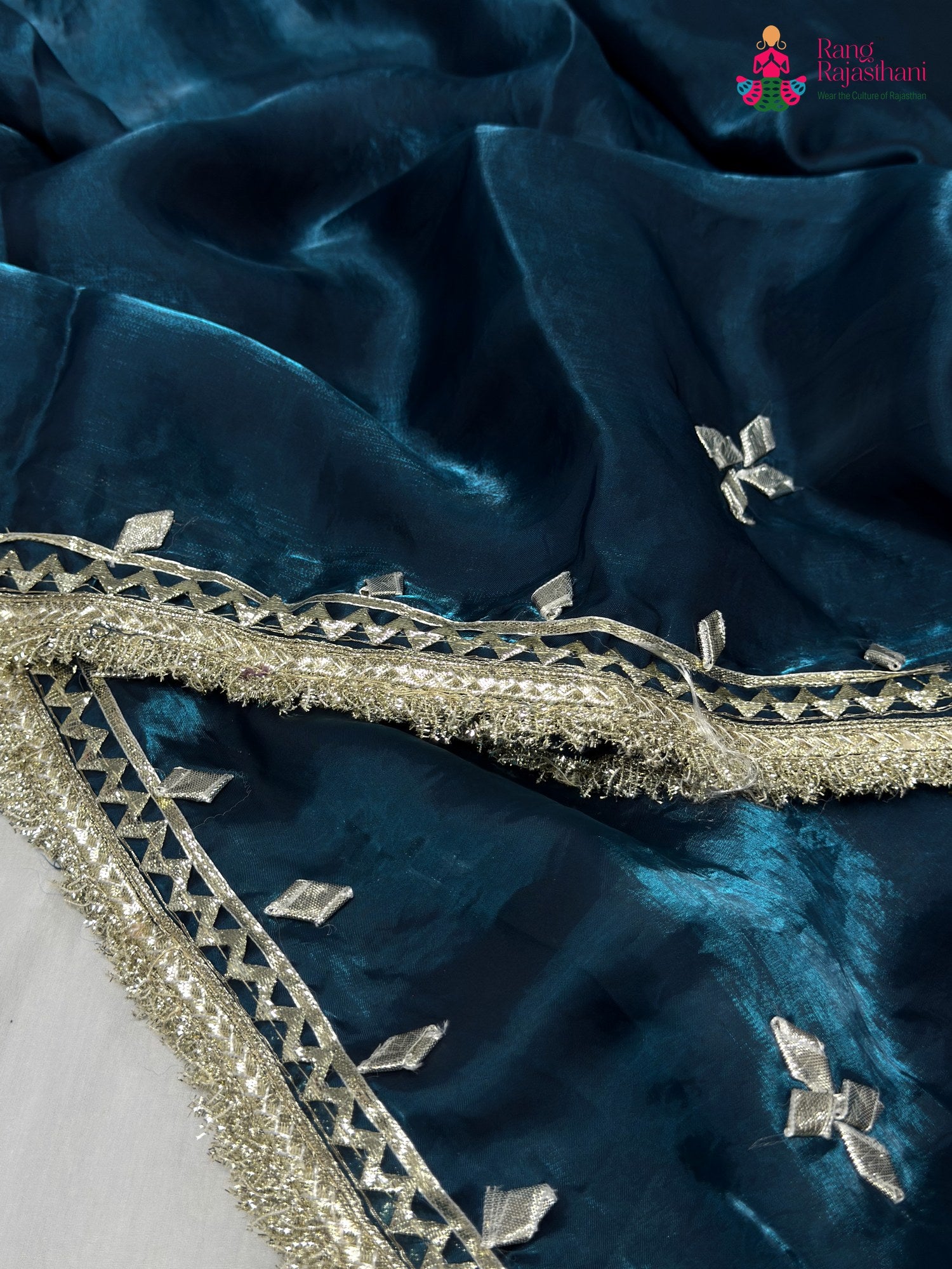 border detail of blue synthetic gota patti saree
