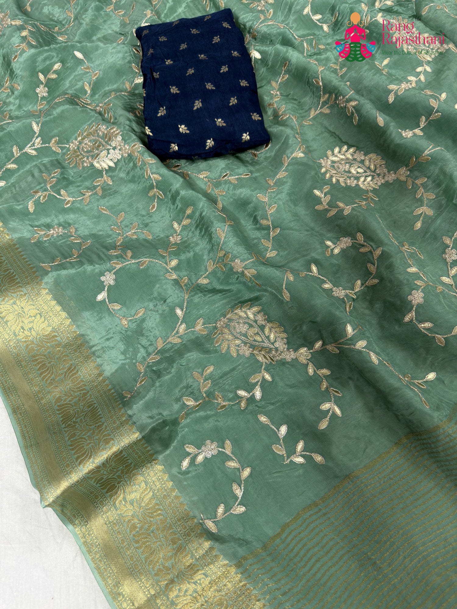 work detailing of breathable see green chinnon saree