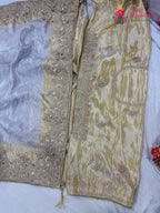 border detailing of cream pure tissue silk zari embroidery saree