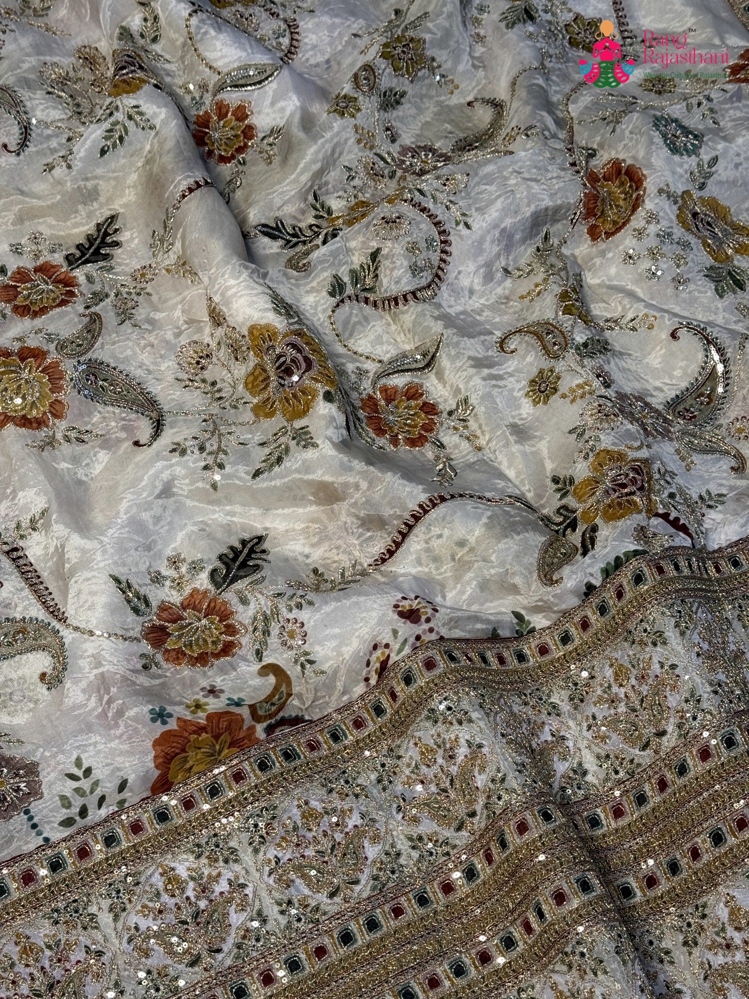 close up detailing of cream pure tissue silk zari embroidery saree