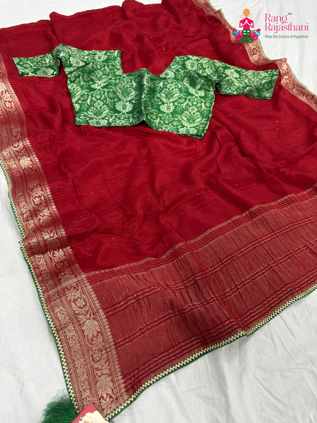 border detailing of festive red fabric saree