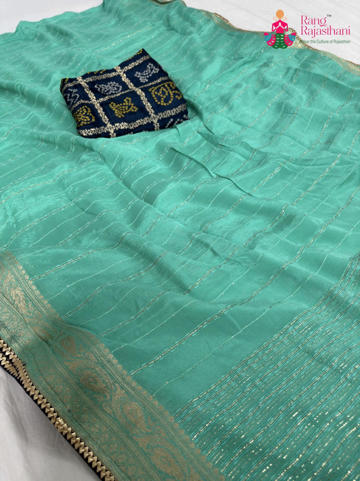 close up detailing of firozi chinnon bandhani saree