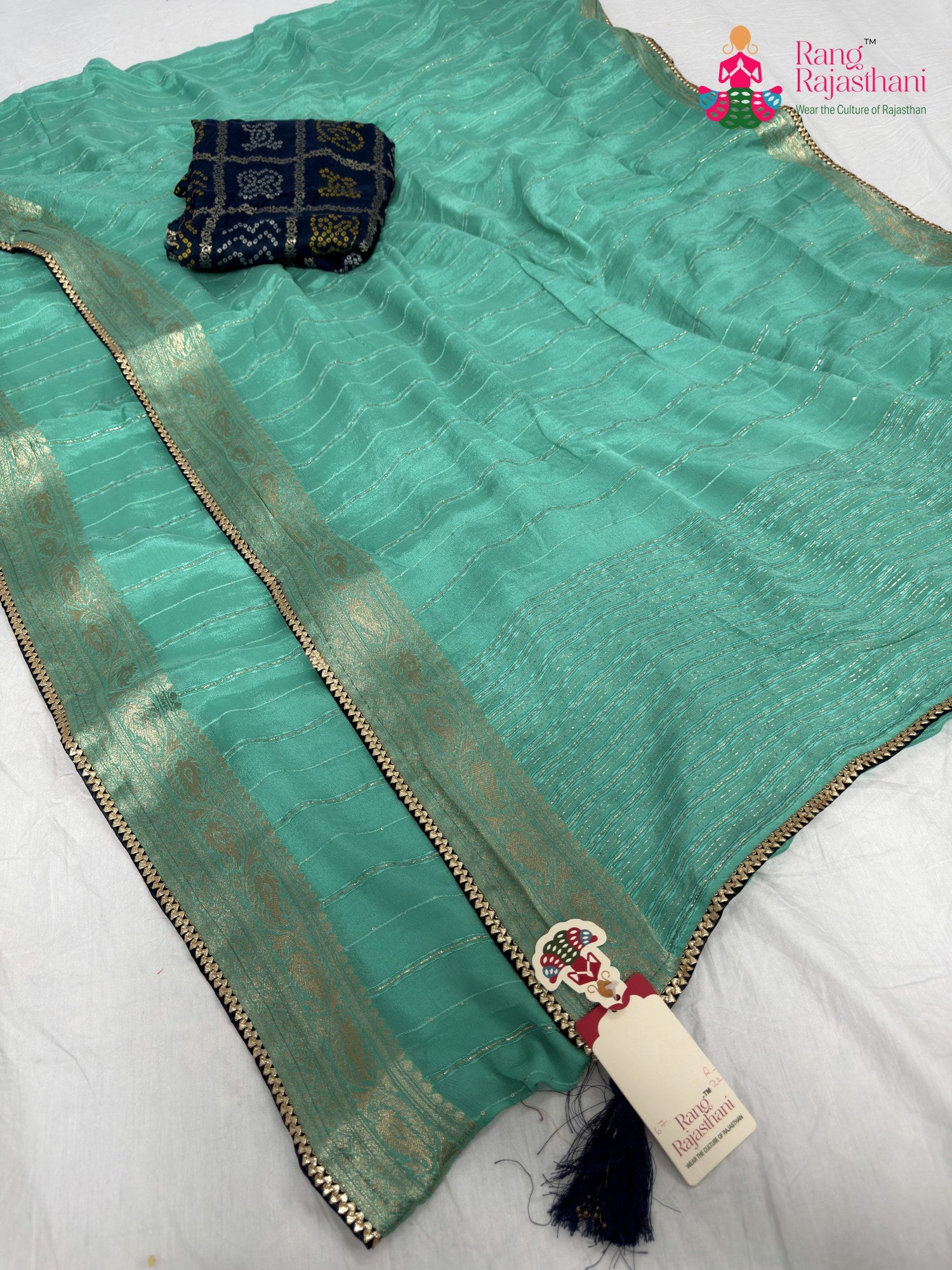 border detailing of firozi chinnon bandhani saree
