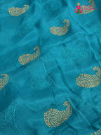 close up view of firozi chinnon zari embroidery saree