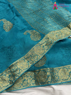 border detail of firozi chinnon zari embroidery saree