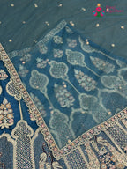 border detail of firozi net zari embroidery saree