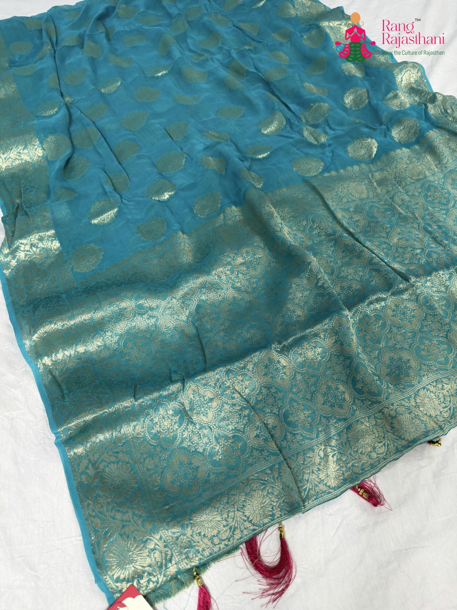close up detailing of firozi soft georgette banarasi zari weave saree