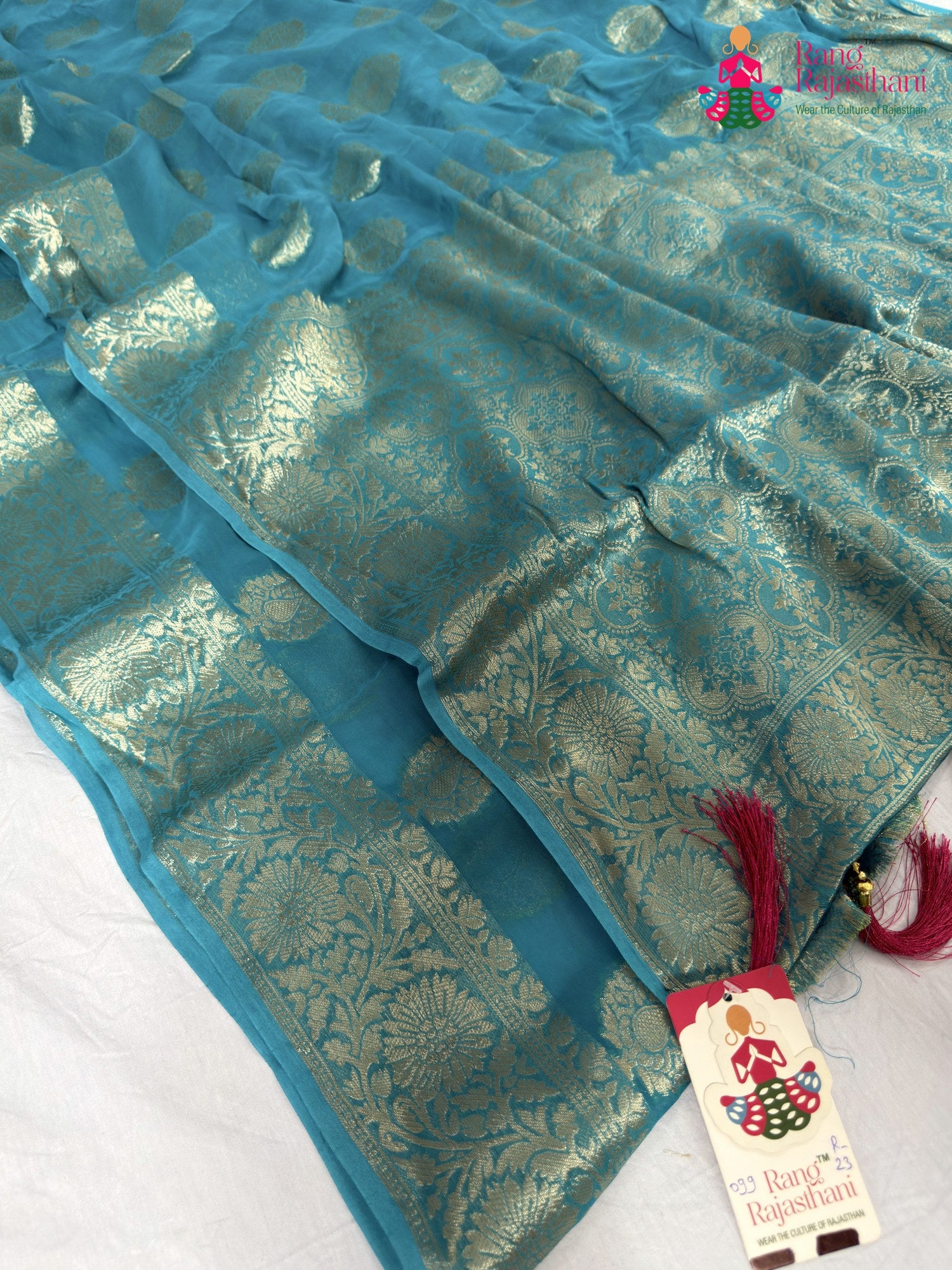 border detailing of firozi soft georgette banarasi zari weave saree