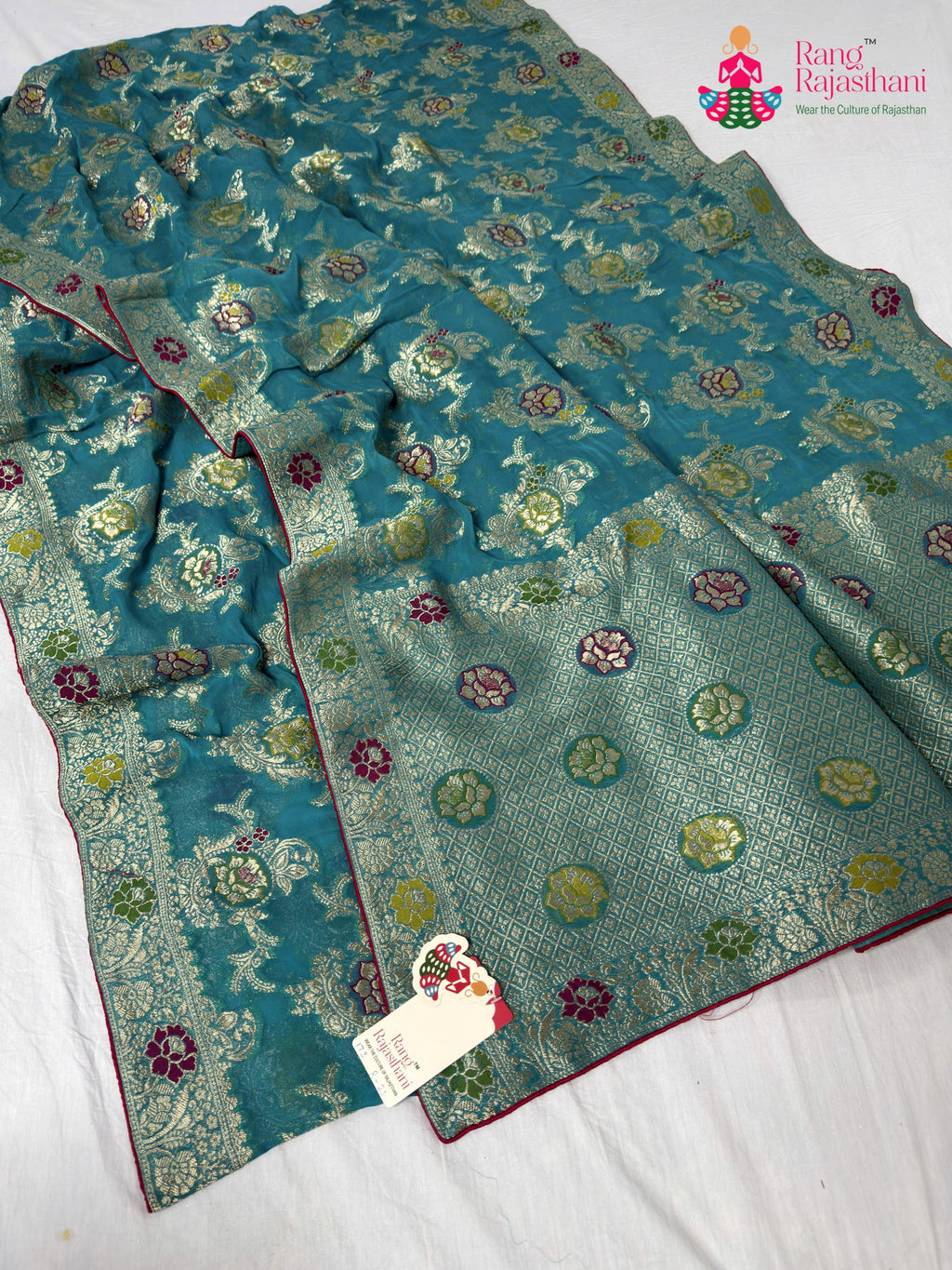 close up detailing of firozi soft georgette meenakari zari saree