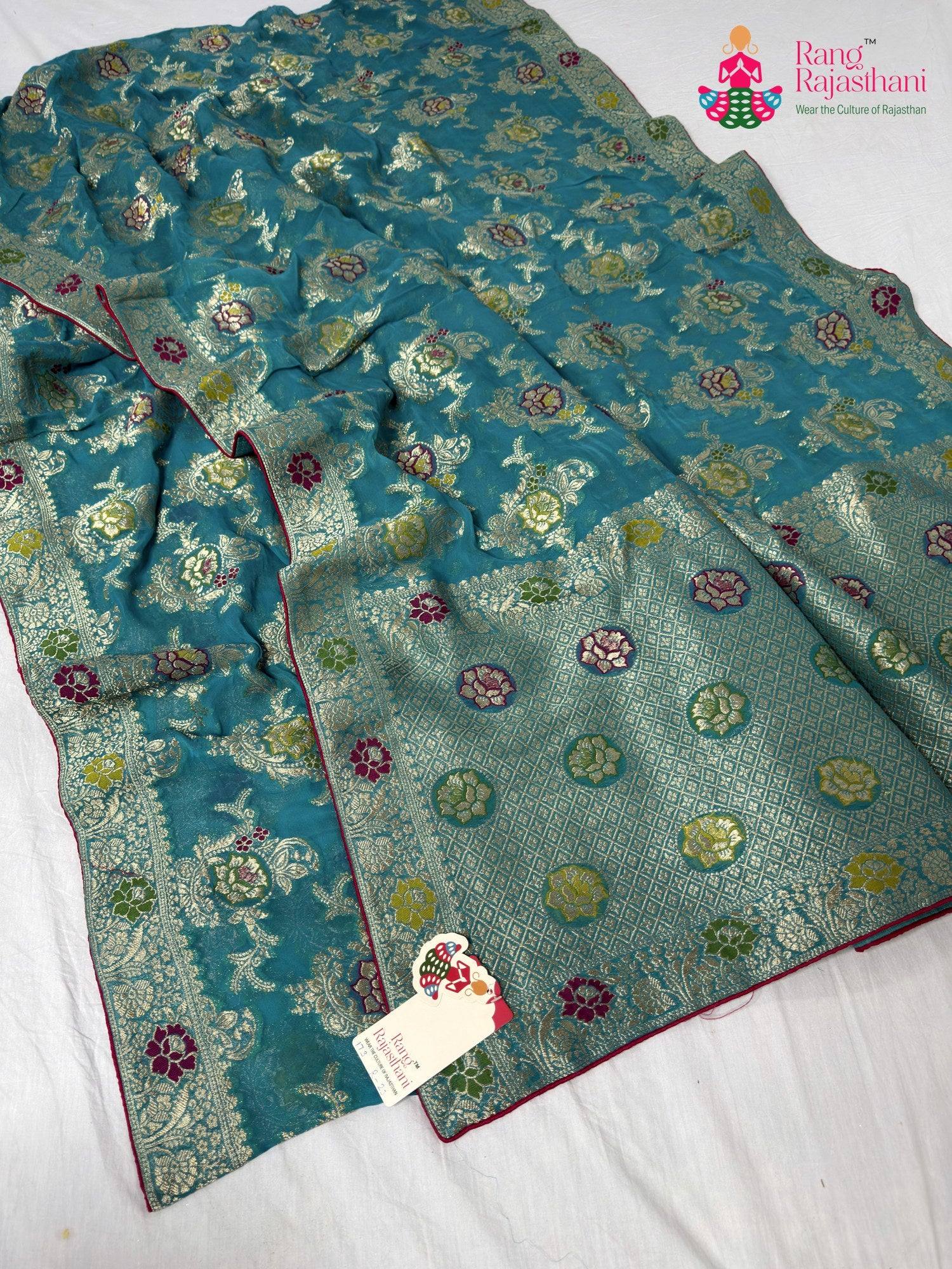 close up detailing of firozi soft georgette meenakari zari saree