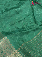 design pattern of green chinnon jacquard weave saree