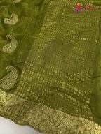 border detail of green chinnon zari embroidery saree