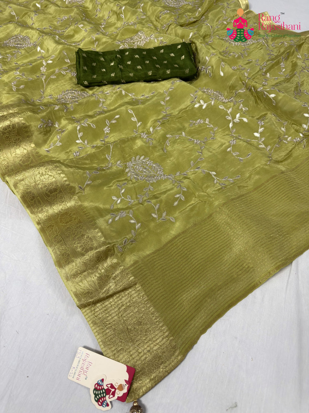 close up detailing of green pure ho silk zari embroidery saree