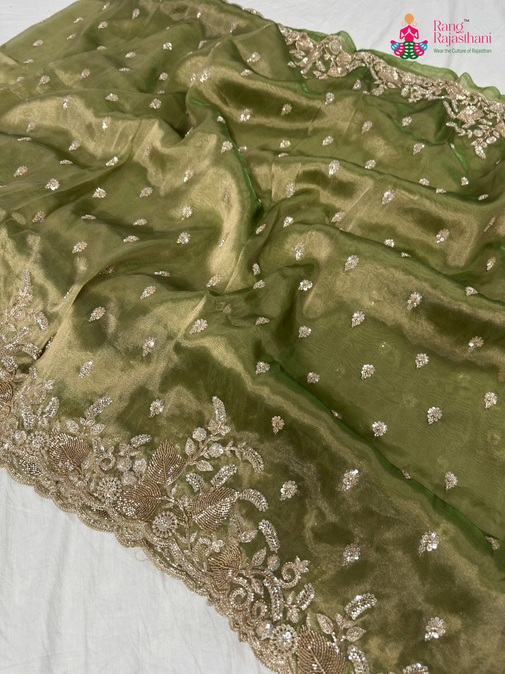 close up detailing of green synthetic hand embellishment saree