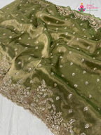 close up detailing of green synthetic hand embellishment saree