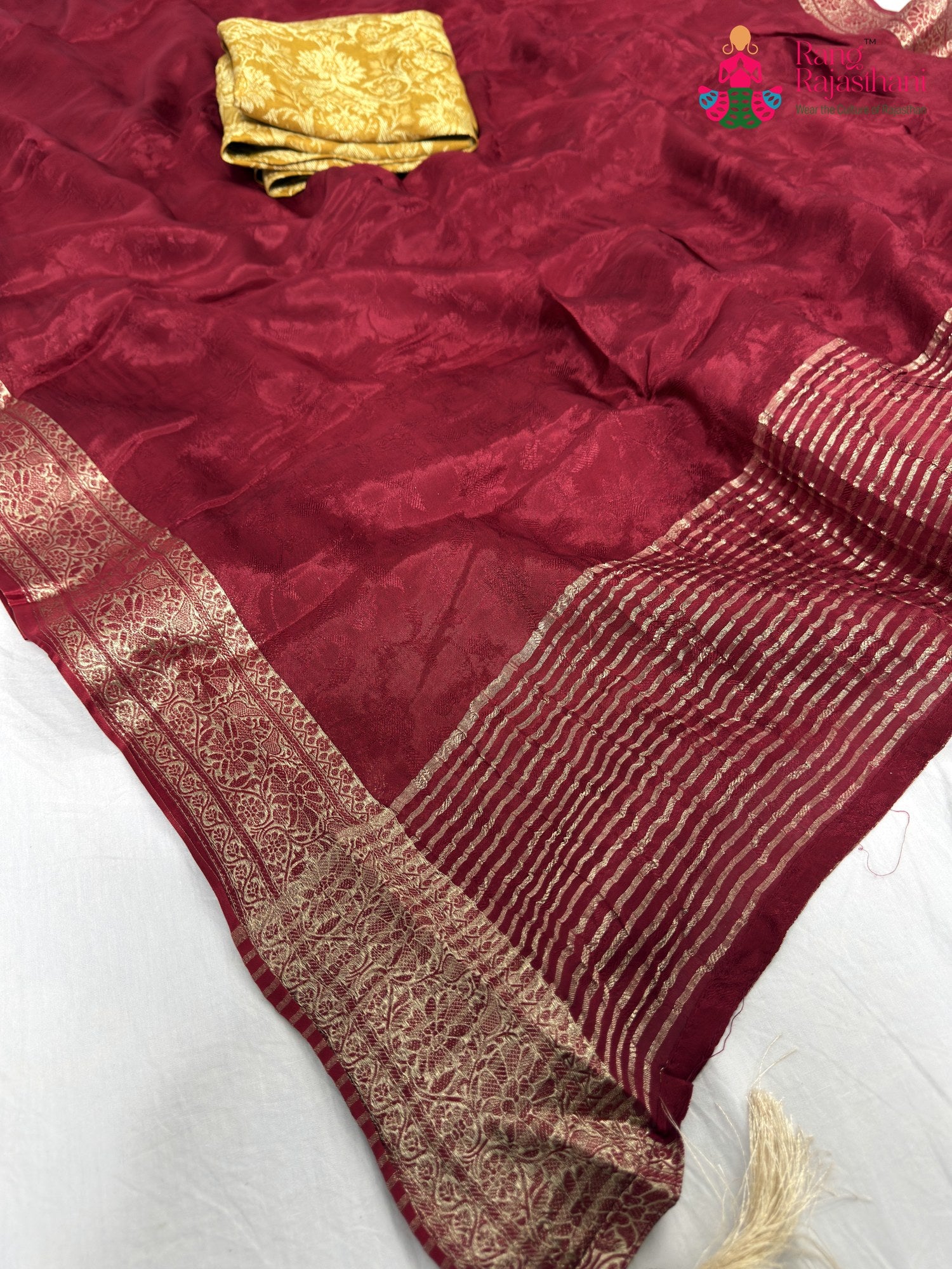 close up detailing of maroon chinnon jacquard weave saree