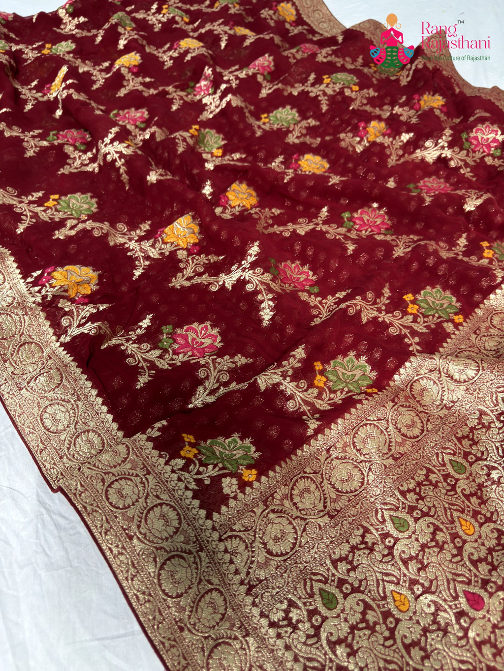 close up detailing of maroon soft georgette meenakari zari saree
