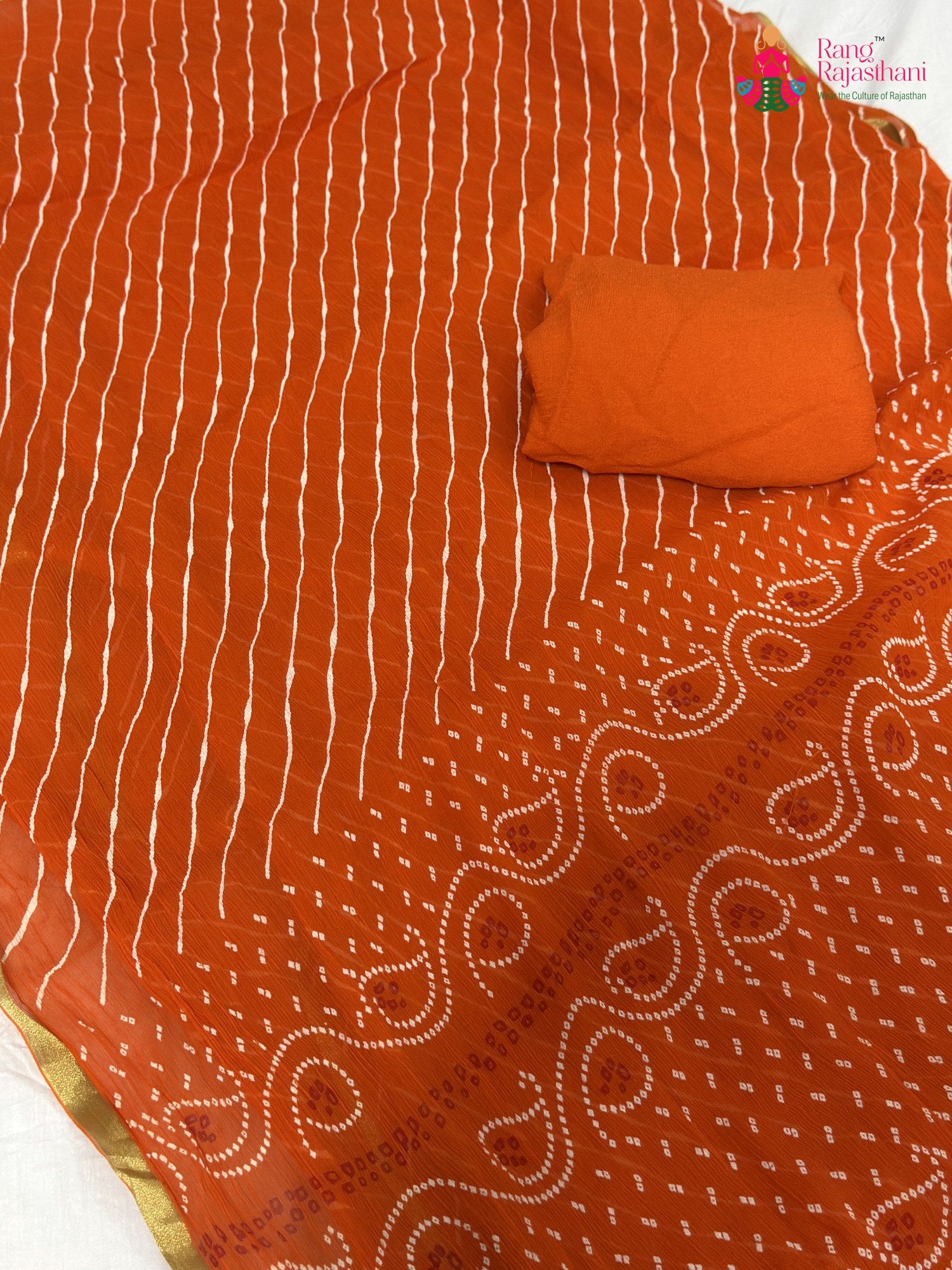 close up view of orange chiffon saree