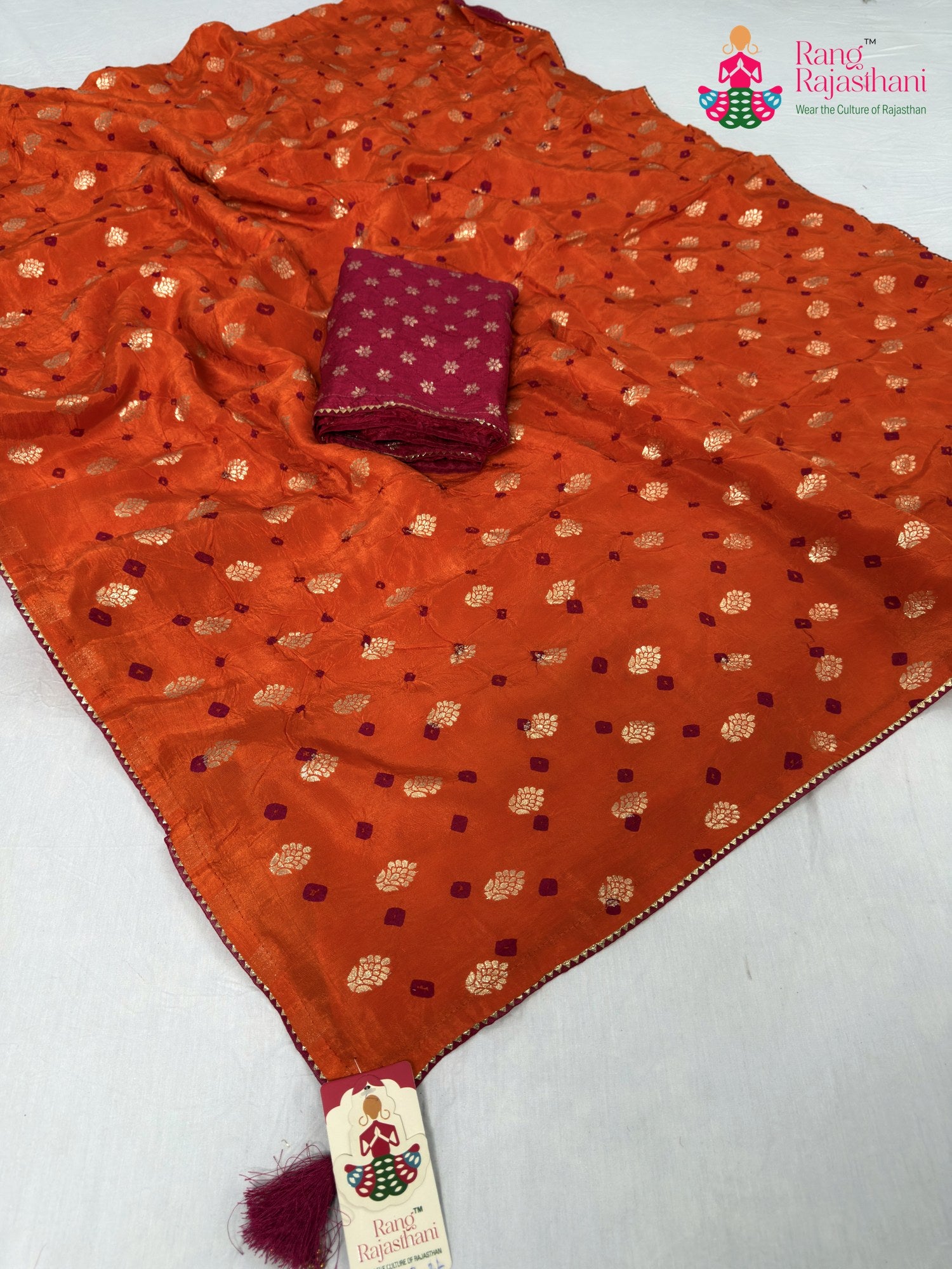 pallu detailing of orange pure dola silk bandhani saree