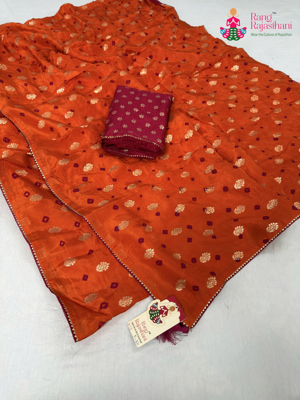 close up detailing of orange pure dola silk bandhani saree