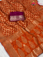 fabric texture of orange pure dola silk bandhej banarasi zari saree