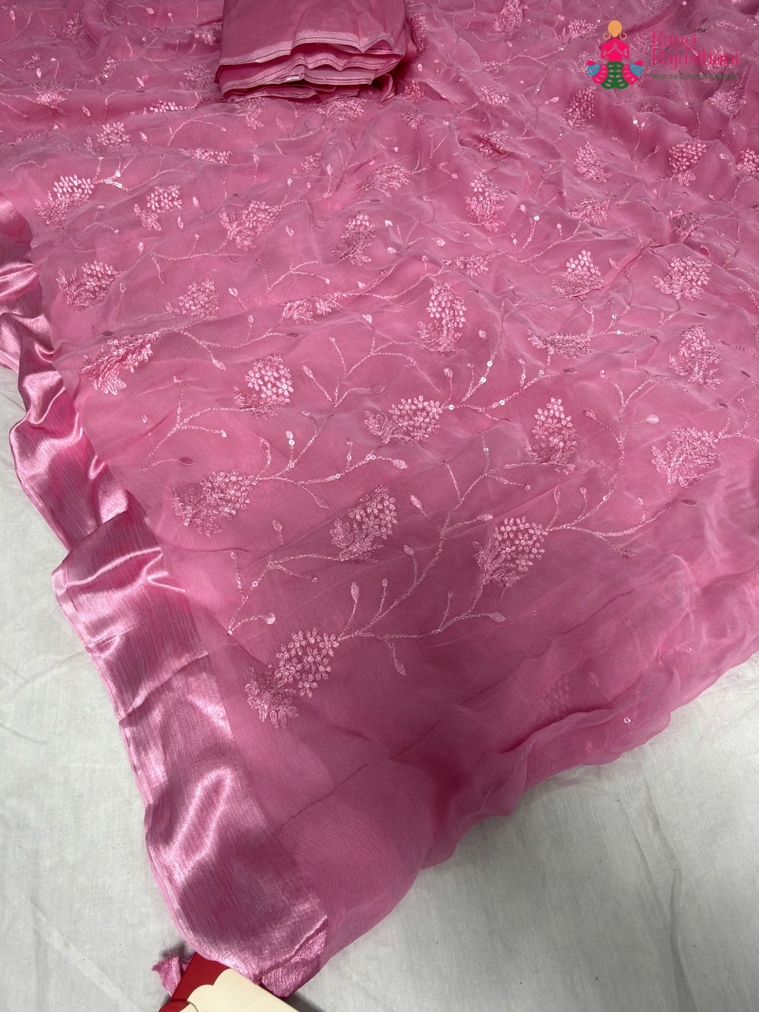 close up detailing of pink chiffon resham embroidery saree