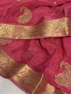 close up view of pink chinnon zari embroidery saree