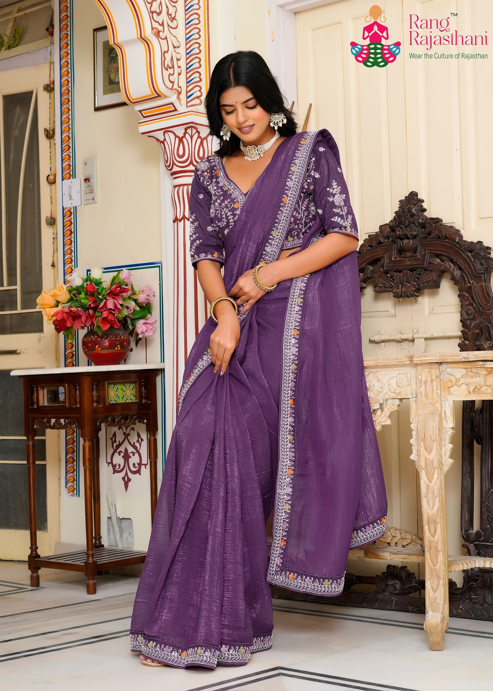 close up detailing of purple fabric saree 