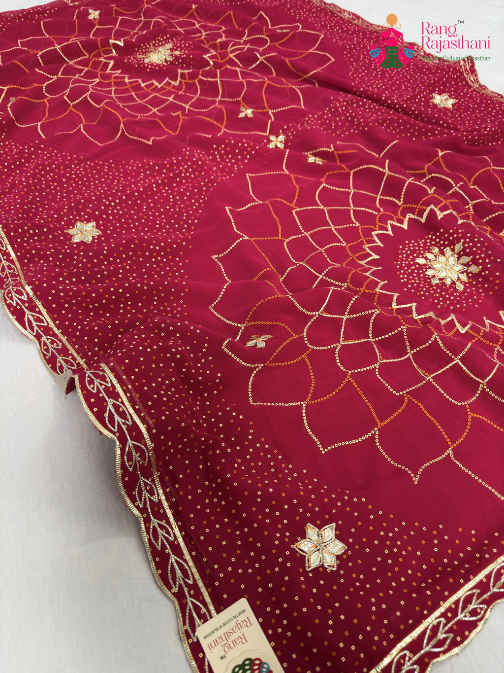 close up detailing of rani synthetic bandhani saree