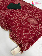 close up detailing of red chiffon bandhani saree