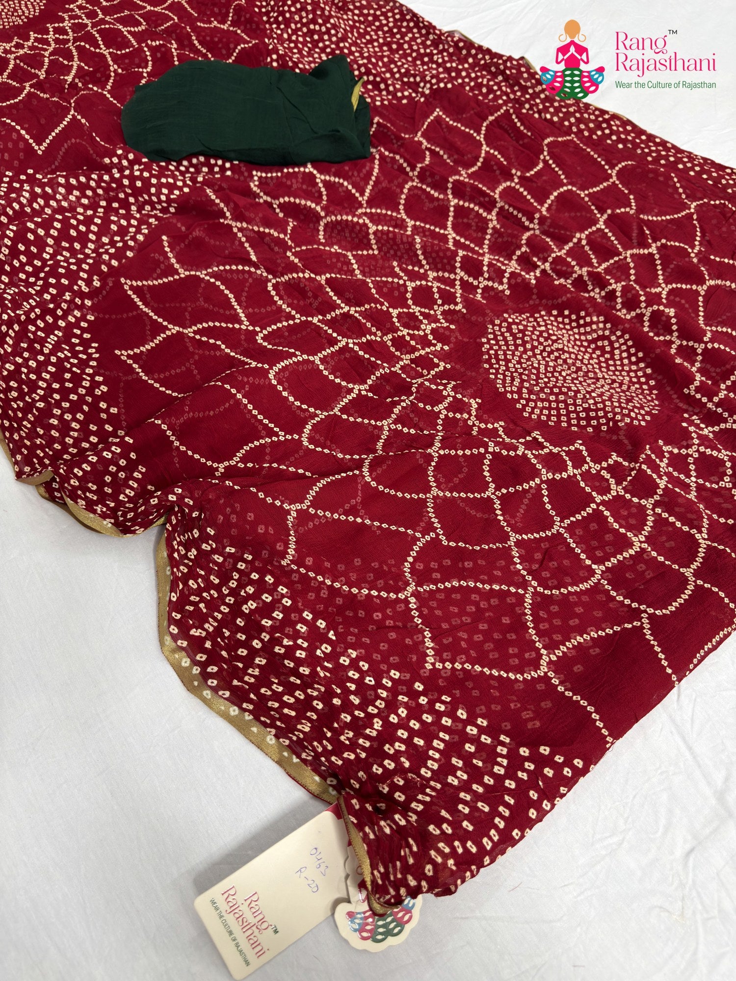 close up detailing of red chiffon bandhani saree