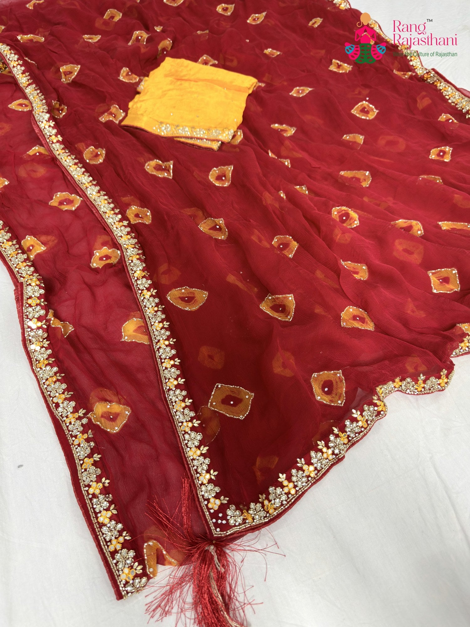 close up detailing of red chiffon hand embellishment saree