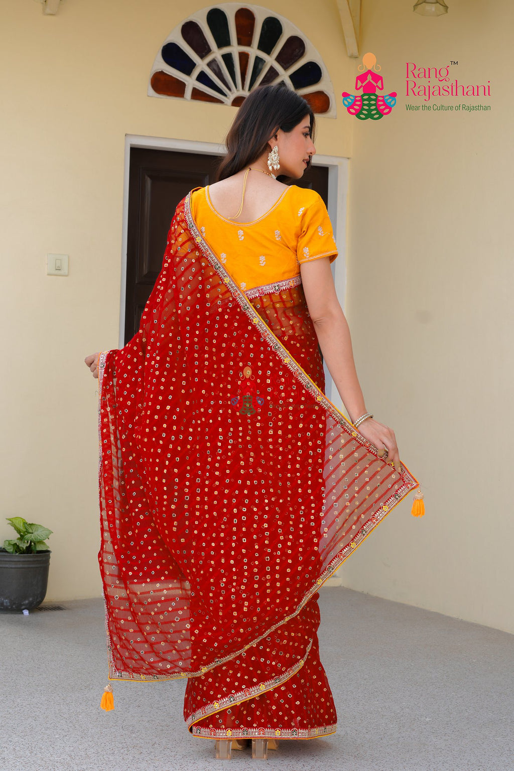 close up detailing of red chiffon saree 