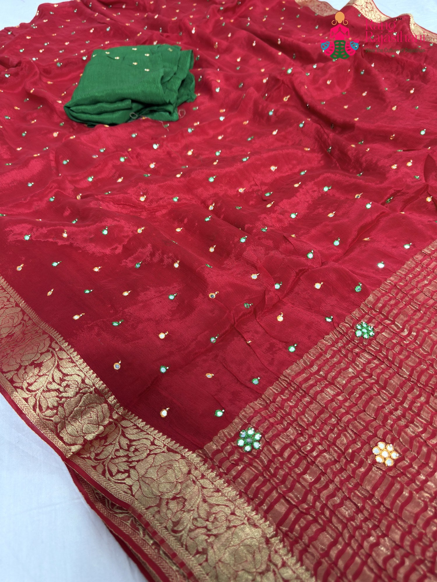 close up detailing of red chinnon banarasi zari weave saree