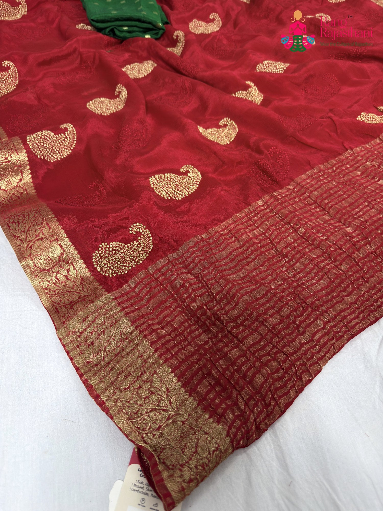 pallu detailing of red chinnon zari embroidery saree