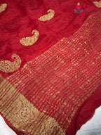 pallu detailing of red chinnon zari embroidery saree