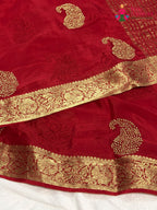 close up view of red chinnon zari embroidery saree