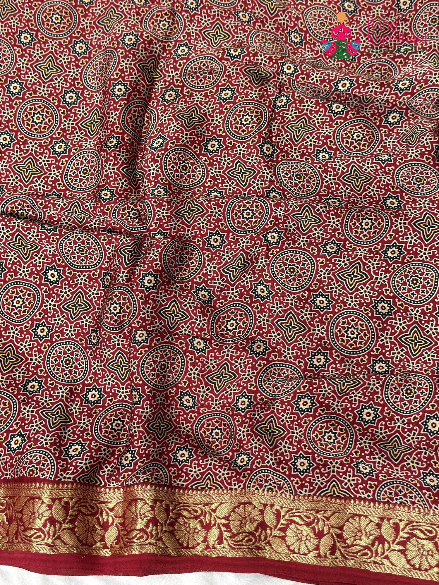 close up view of red modal banarasi zari weave gharchola saree
