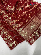 border detailing of red modal bandhani saree