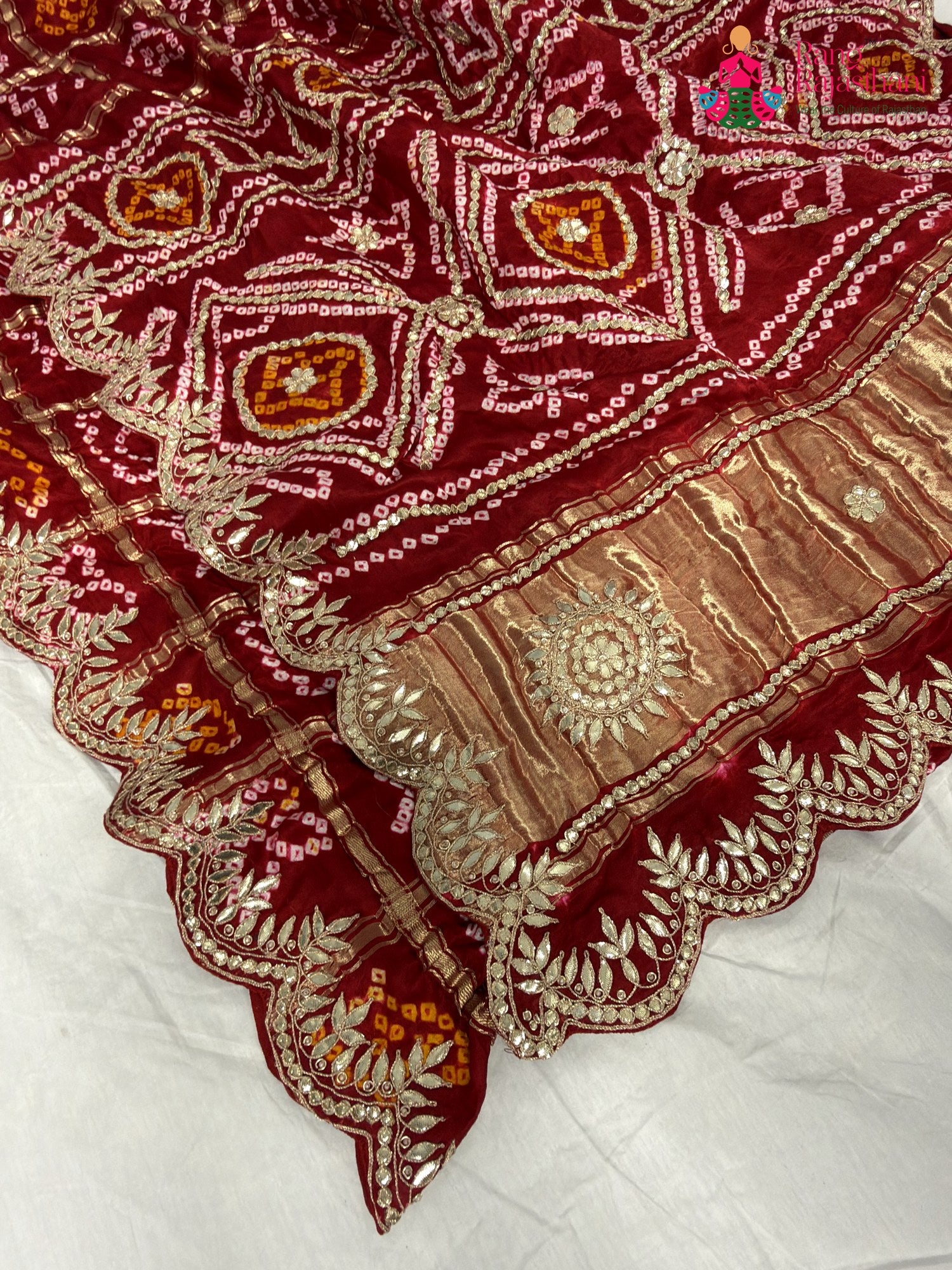 border detailing of red modal bandhani saree