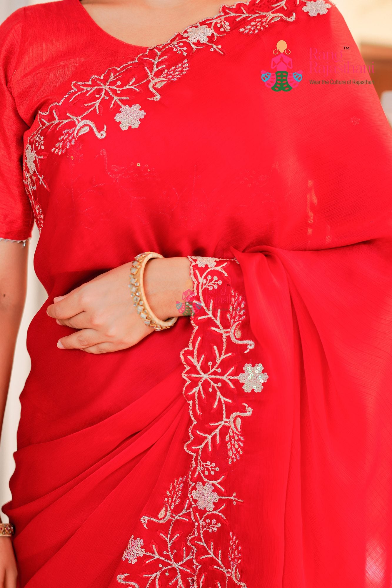 red synthetic chiffon saree with figure work for sister's wedding close-up view