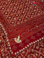 chunni detail of red pure dola silk bandhani lehenga chunni