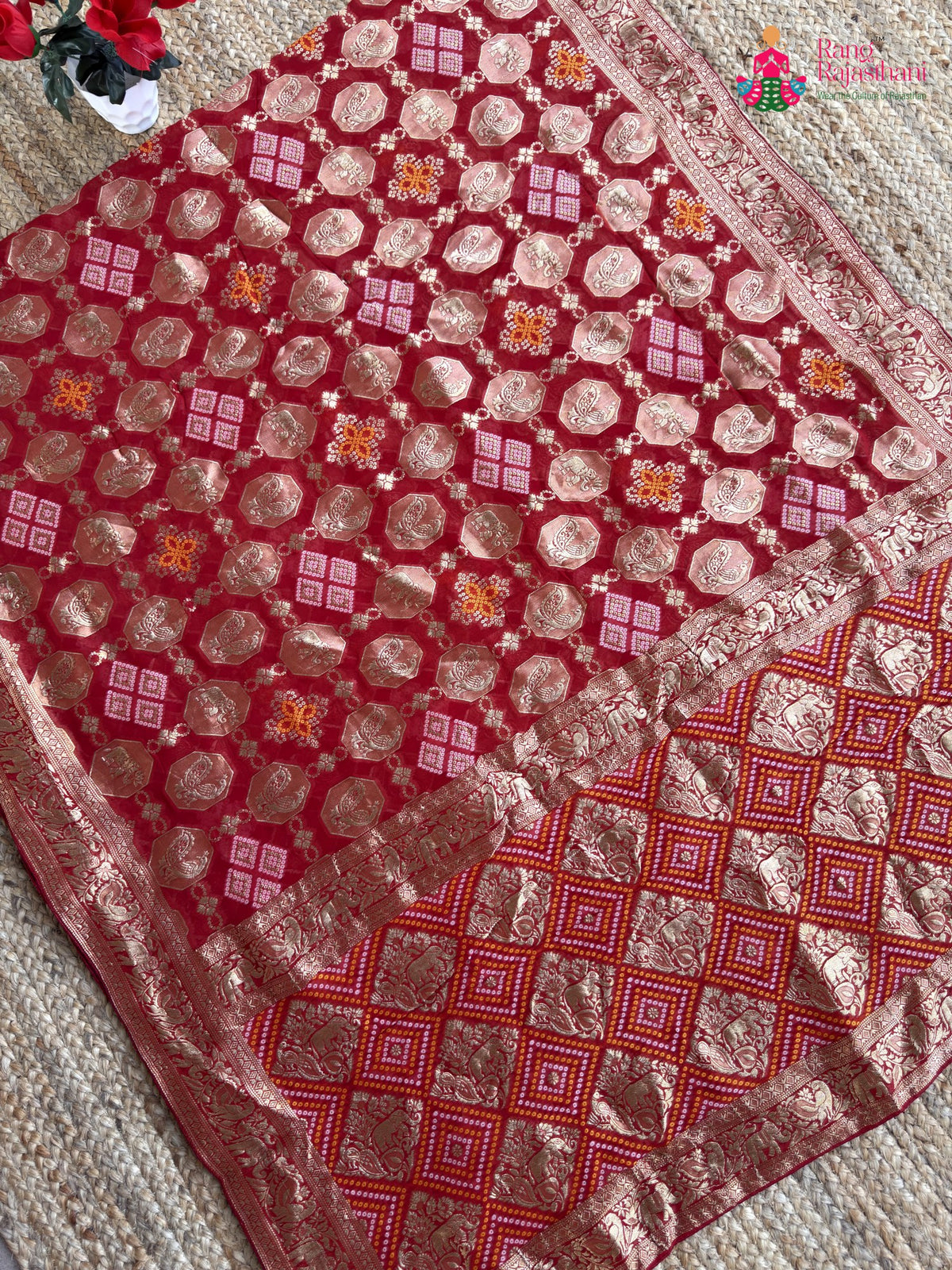 pallu detailing of red soft georgette banarasi zari weave gharchola saree
